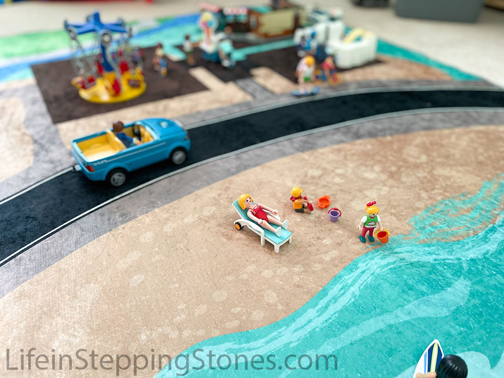 Beach theme play rug and activity mat for kids. Wide road fits larger vehicles including Playmobil and Lego.