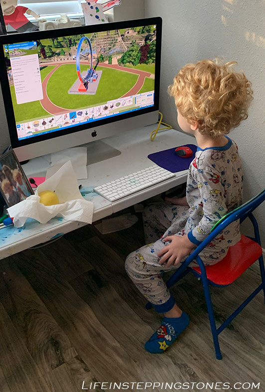 positive screen time for kids - child learns to build theme park and 3D designs on Planet Coaster. Is it really too much screen time if your child is learning new skills? What educational apps or games can your child play?