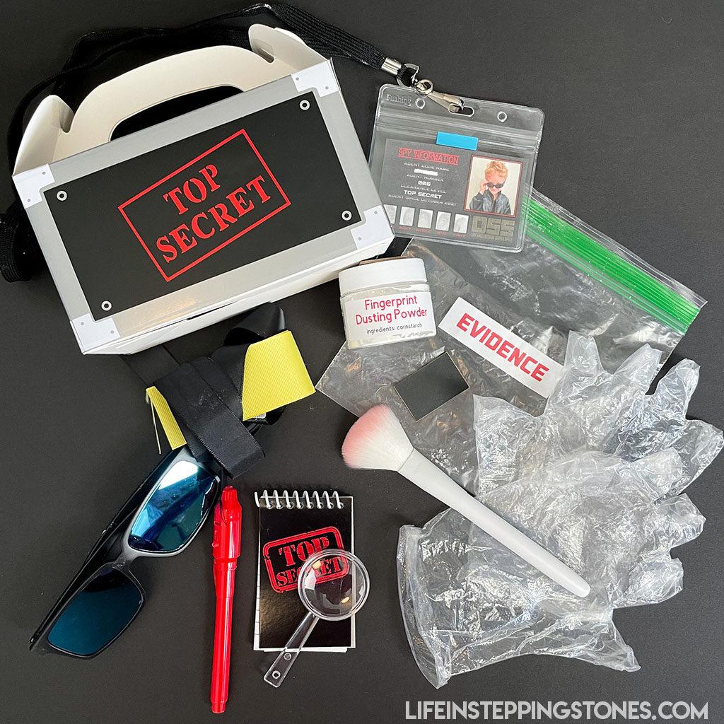 Spy Party Favor Box: Secret Agent Party Favor Box. Create the ultimate Spy Kit for your birthday party guests. Spy ID Badge, Fingerprint Dusting Kit, invisible ink pen, and more.