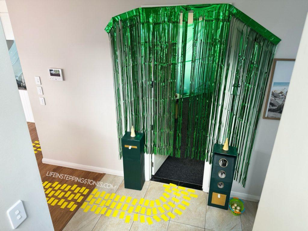 Entrance to the Emerald City for Wicked birthday party with ring the bell ball toss activity