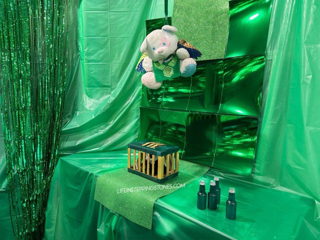 Flying Monkey stuffed animal watches over the caged animal during a Wicked birthday party game