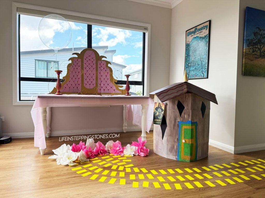 No One Mourns the Wicked birthday party decorations with Wizard of Oz yellow brick road and Glinda's bubble