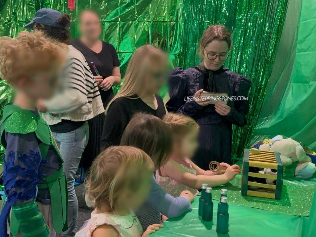 The kids rescue the caged animal in the Emerald City for Wicked birthday party
